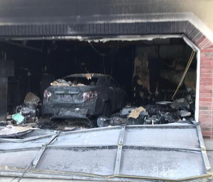 Large garage fire melted the car that was parked inside of it. 